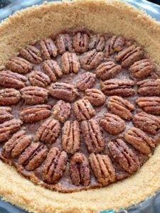 This Healthy Maple Pecan Pie is naturally sweetened and makes a delicious dessert for your table! It can be made vegan and gluten-free with swapping butter for coconut oil and using gluten-free graham crackers or cookies for the pie crust.